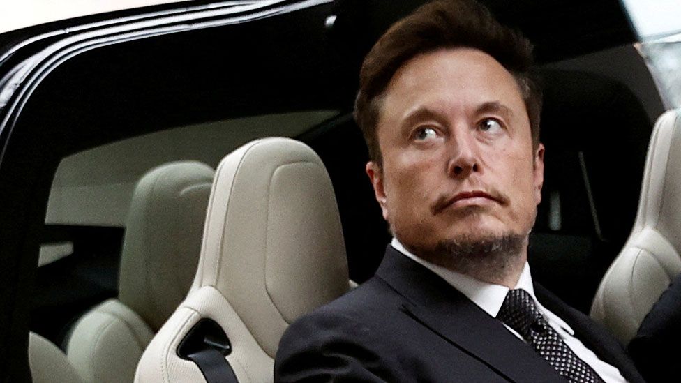 Tesla Chief Executive Officer Elon Musk gets in a Tesla car as he leaves a hotel in Beijing, China, on 31 May 2023